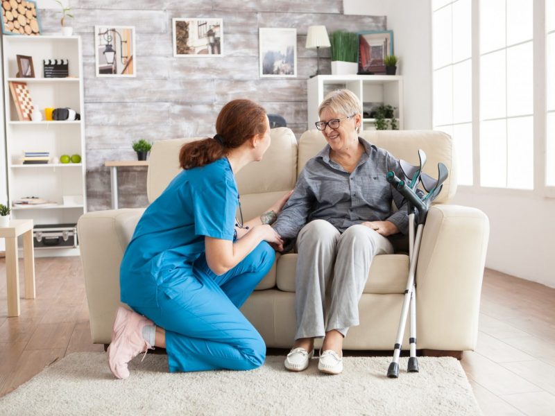 A nurse is talking to an elderly woman.