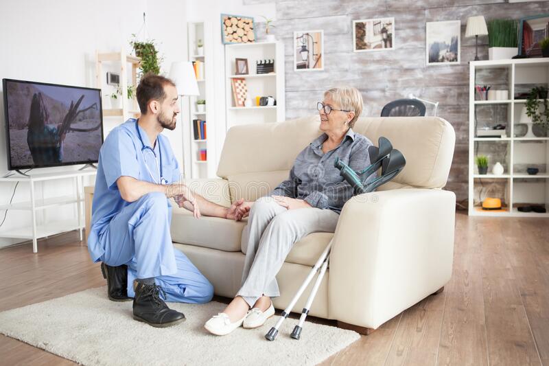 A man sitting on top of a couch next to an older woman.