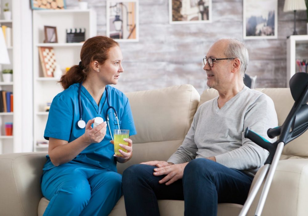 A nurse is talking to an older man.