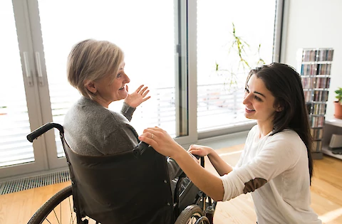 A woman in a wheelchair and another person